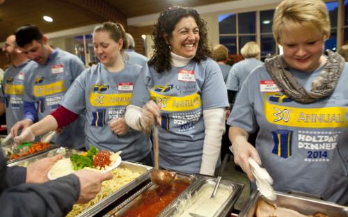 Anna Spragg smiles while serving food at the Undergraduate Holiday Dinner which was held at Quinnipiac University's Carl Hansen Student Center on the Mount Carmel Campus, Thursday, December 4, 2014. Photography by Johnathon Henninger