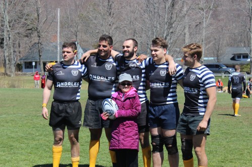 Lauren Loose (front) posed with sophomore Danny Holland, senior PJ Ruttura, sophomore Nik Griswold, senior Matt Sjanzar and senior Paul Thomspon at halftime during Sunday’s charity game.
