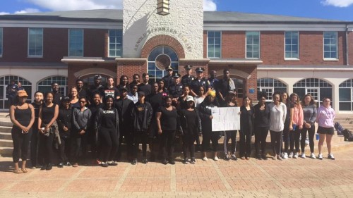 Protesters pose for a photo with Hamden Police officers.