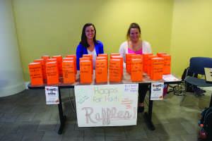 Marie Frey and Lauren Szmak run the Hoops for Haiti raffle table.