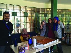 (From left to right) Imam Sami, Hamna Mahboob, Taqua Naeem, Annie Ishfaq and Ayah Galal serve pizza.